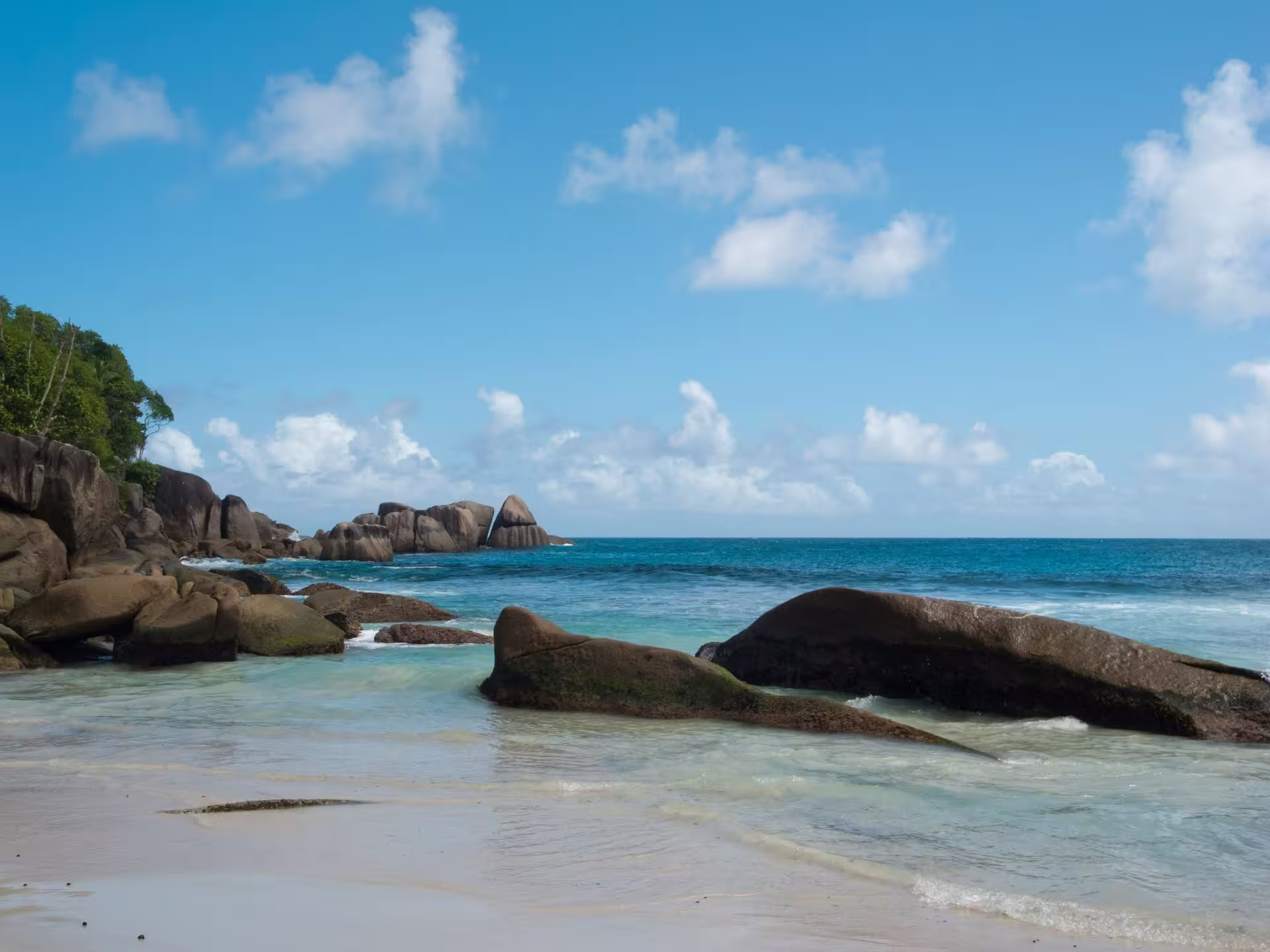 Boats and sandy shore at Anse Volbert, Praslin Island